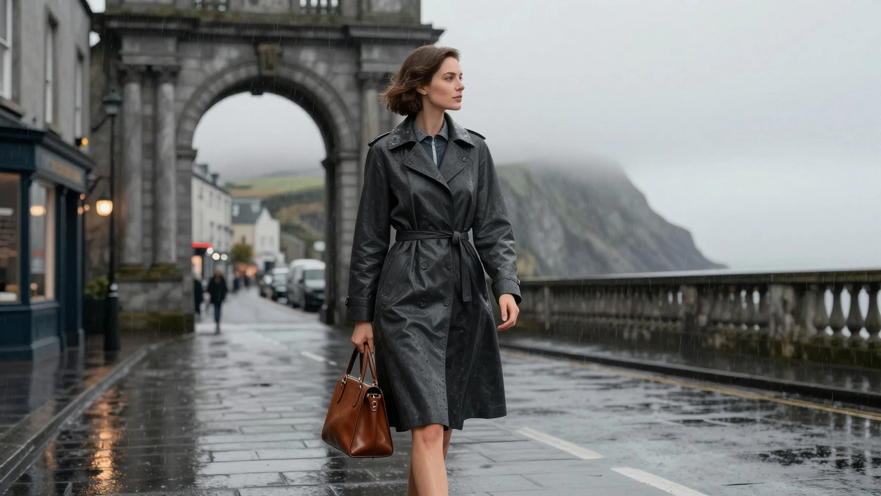 Woman walking through Galway’s Spanish Arch in a charcoal coat dress, rain-slicked streets and foggy cliffs behind.