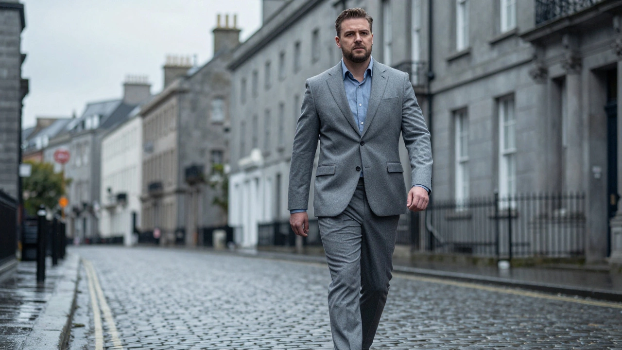 Confident man in tailored suit walking on cobblestone city street
