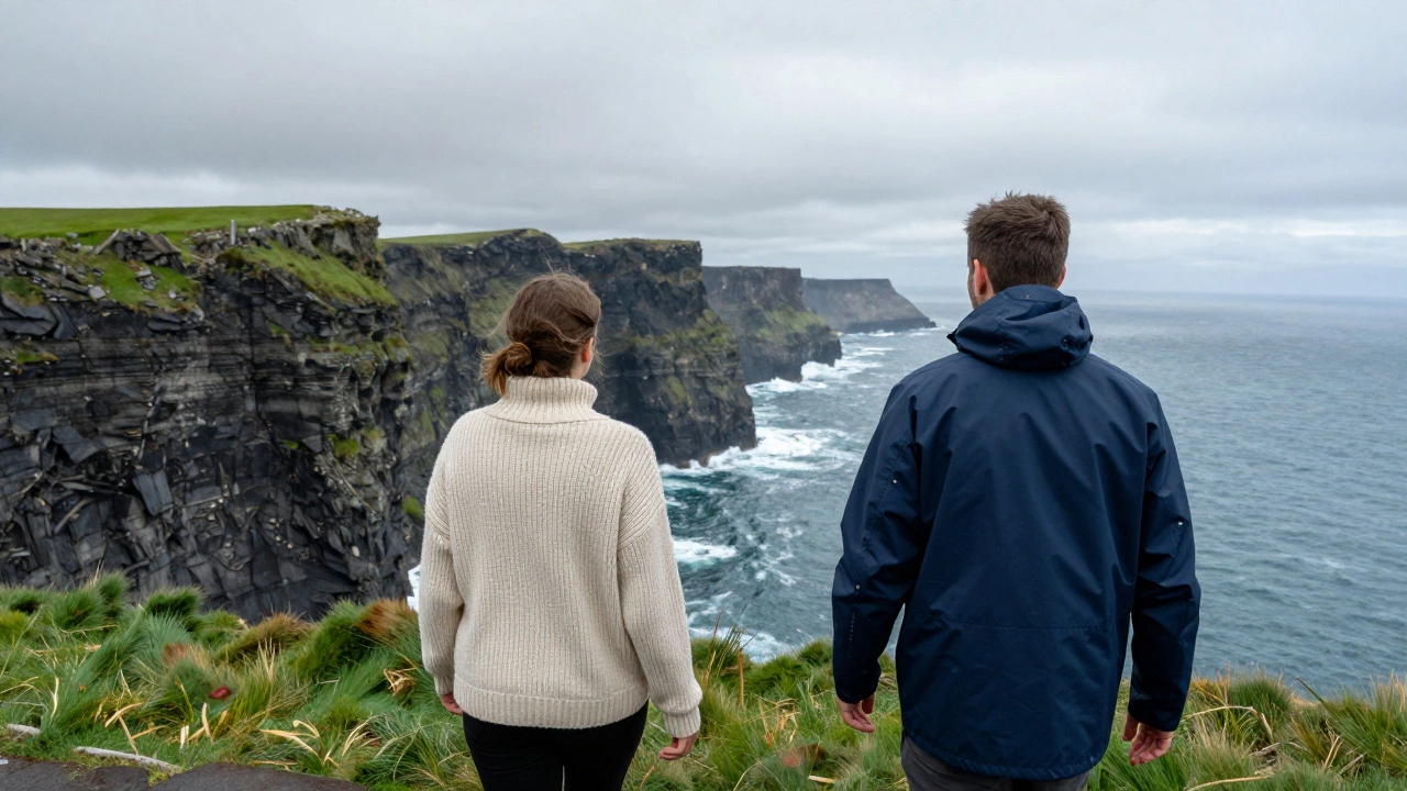 People wearing a wool sweater and a hoodie while walking along the Cliffs of Moher.