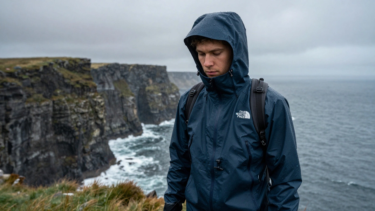 Hiker in waterproof hooded jacket on misty Irish cliffs