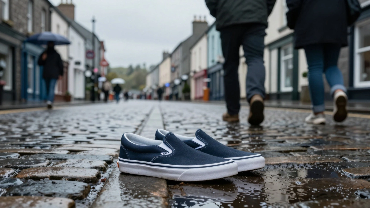 Waterproof slip-on shoes on wet Irish cobblestones reflecting grey sky and puddles.