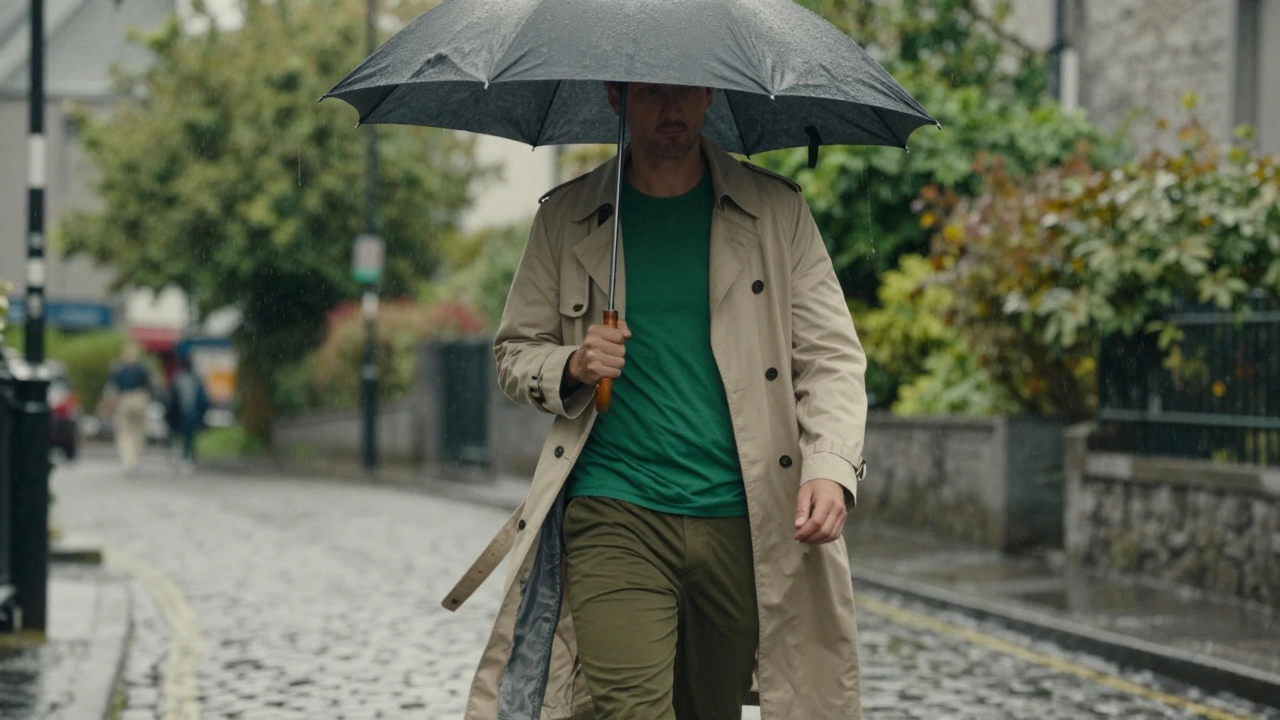 Figure in forest green coat walking on rainy Galway street